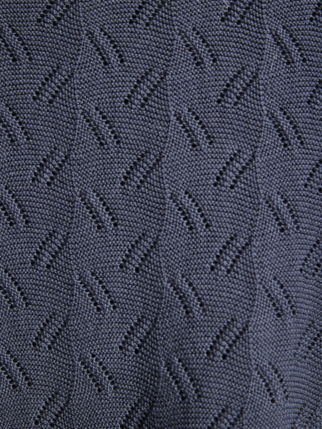 Close-up of textured dark fabric with a geometric pattern