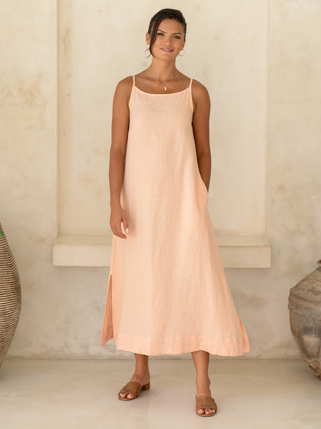 Model wears Peony Linen Dress in Coral