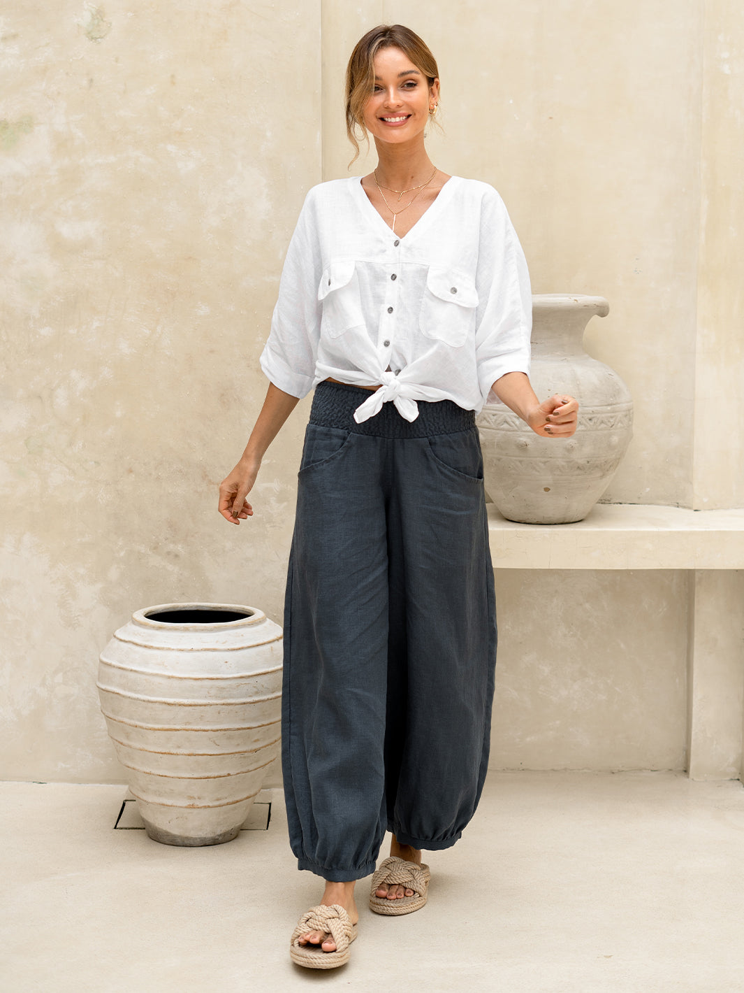 Model wears Sadhu French Linen Pants Regular in Charcoal.