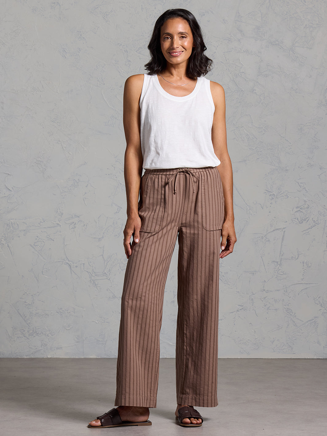 Woman wearing Sidari Organic Cotton Trousers Cinnamon from Nomad the Label