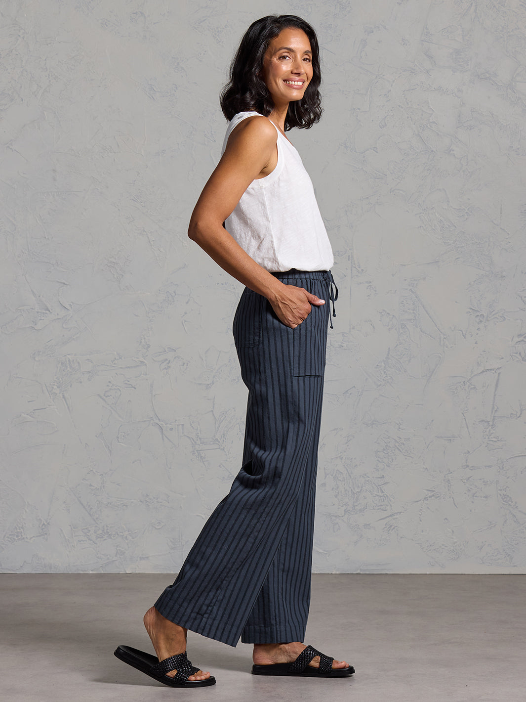 Woman wearing Sidari Organic Cotton Trousers Charcoal from Nomad the Label