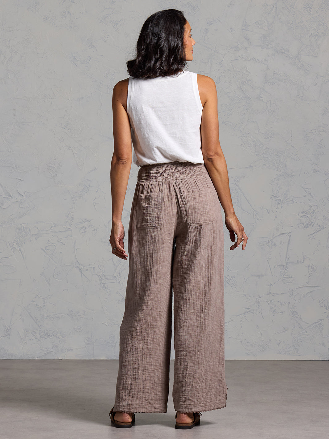 A woman wearing Sur Mer Organic Cotton Trousers Elm and Yarra Cotton Top Coconut from Nomad the Label