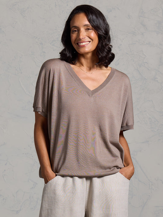 A woman wearing Toscana Merino Wool Top Elm and Sadhu French Linen Pants Flax