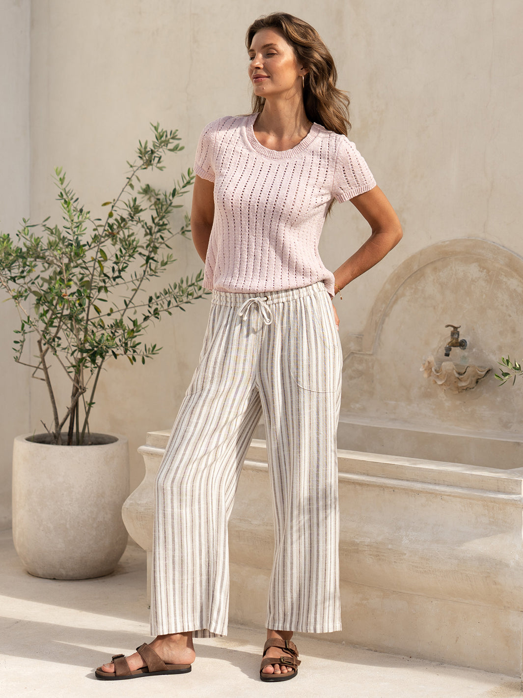Full length view of the Jolie Linen Blend Trousers in driftwood, paired with a pink knit top.