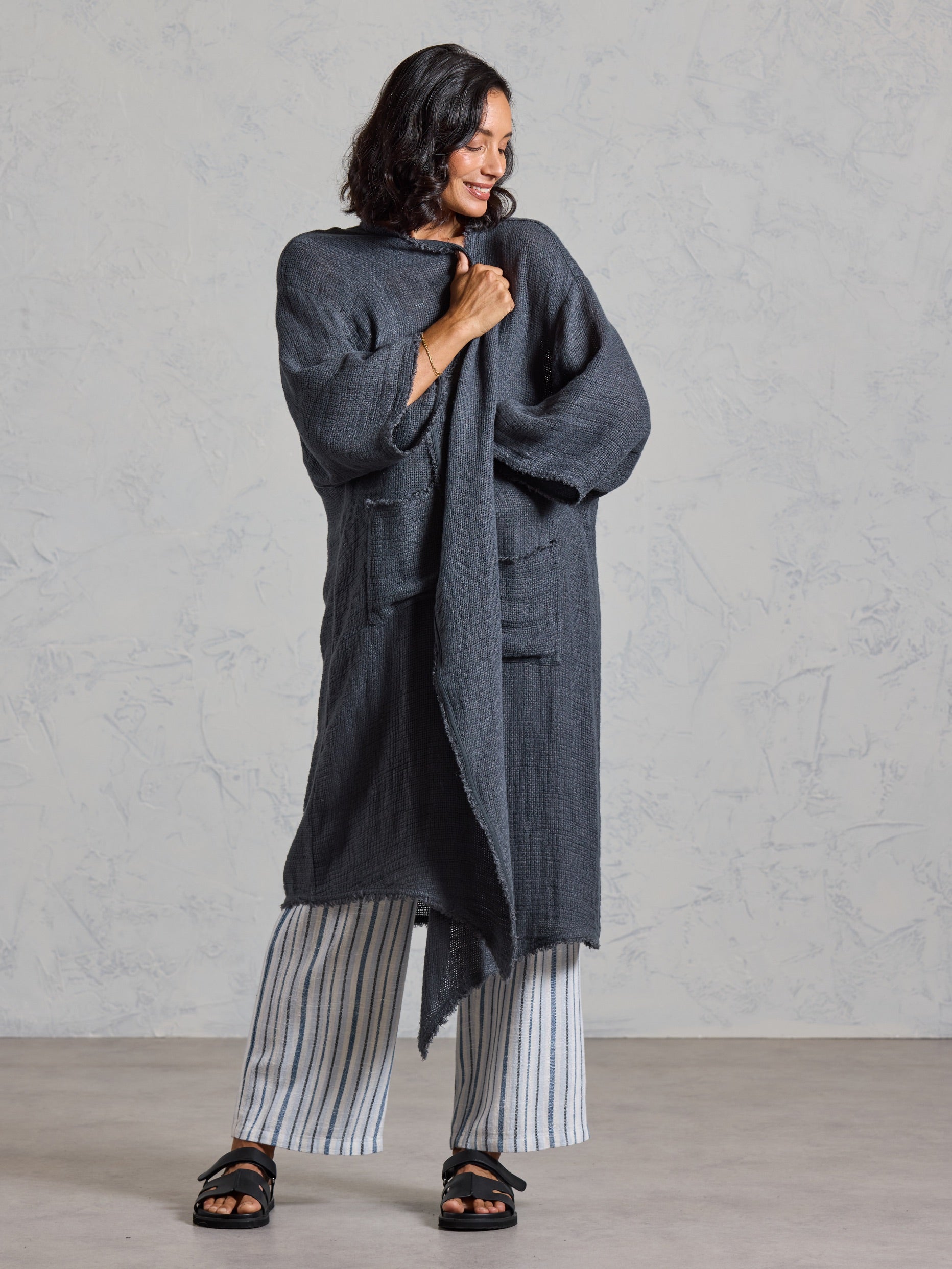 Studio detail of the Laguna French Linen Kimono in charcoal, showing the front opening and fringed trim.