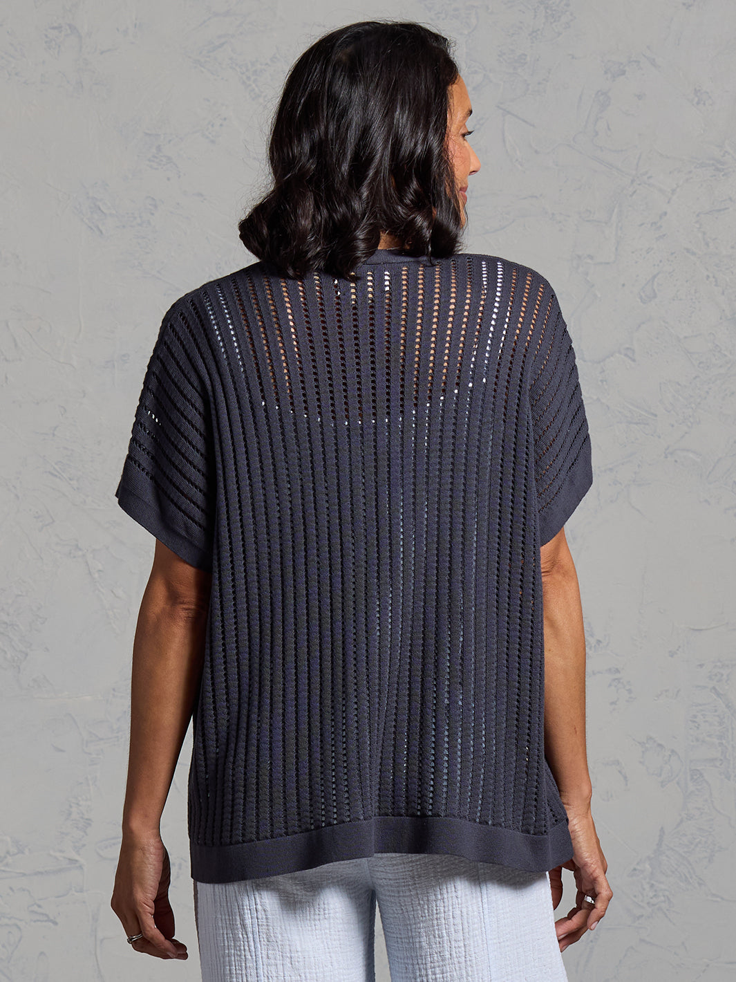 A woman wearing a charcoal cotton kimono from Nomad the Label