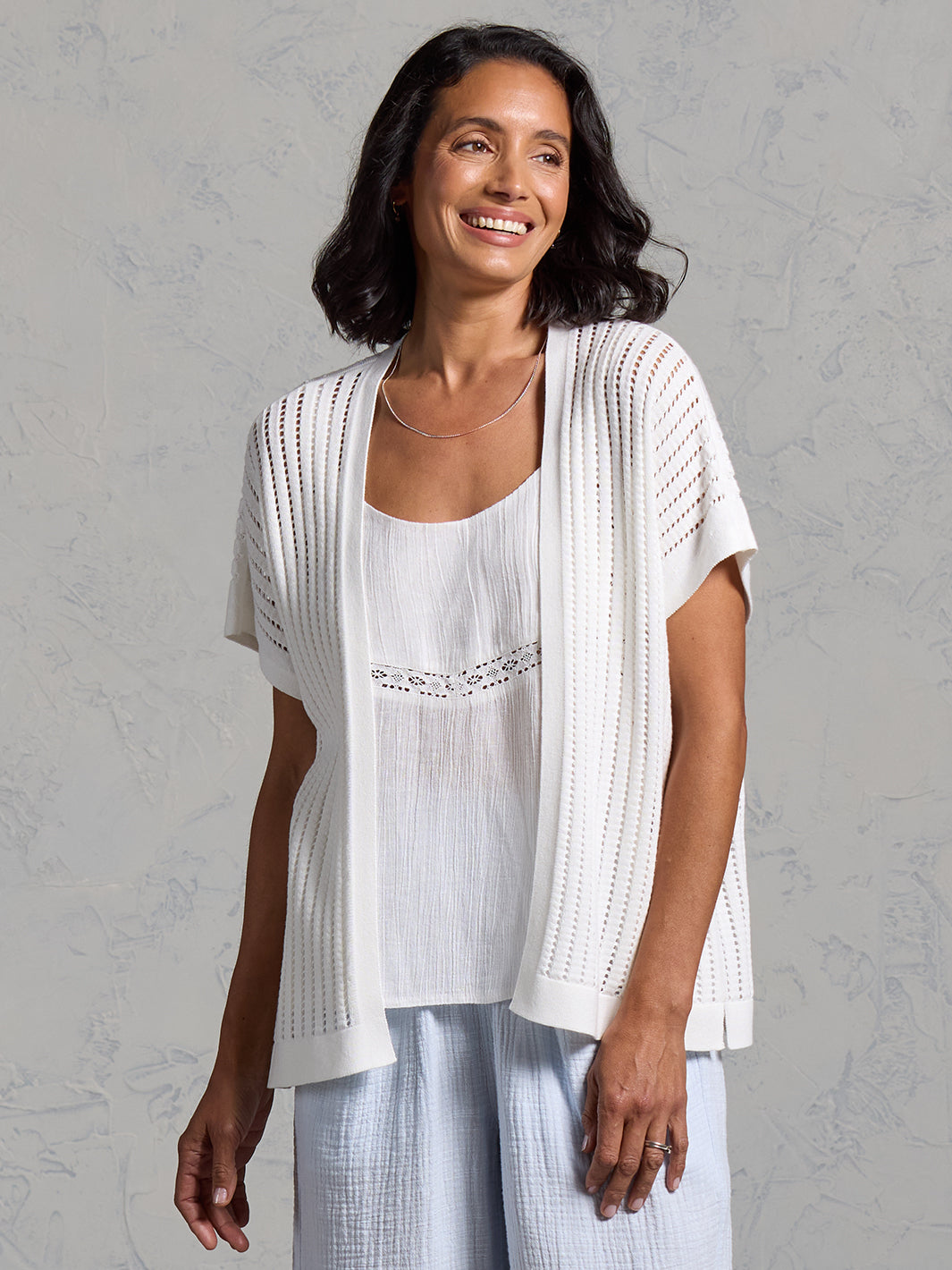 A woman wearing a coconut cotton kimono from Nomad the Label