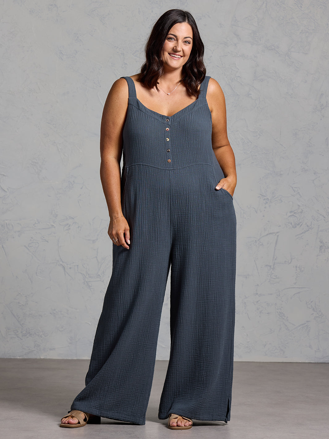 A woman wearing a charcoal cotton jumpsuit from Nomad the Label
