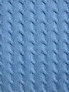 Close-up of blue textured fabric with cable knit pattern