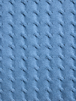 Close-up of blue textured fabric with cable knit pattern