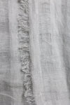 Close-up of a gray fabric with frayed edges
