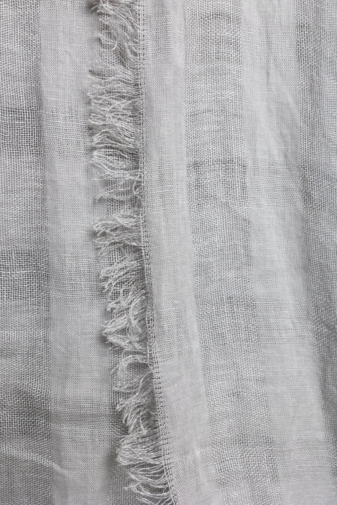 Close-up of a gray fabric with frayed edges
