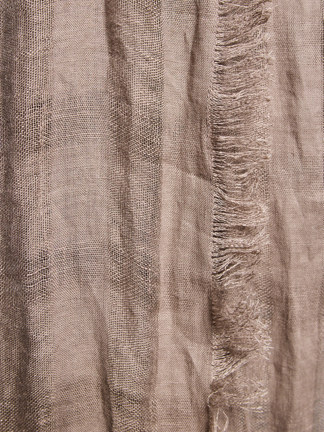 Close-up of textured fabric with frayed edge