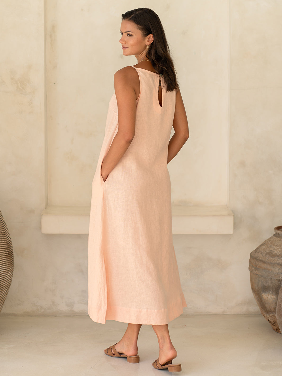 Model wears Peony Linen Dress in Coral