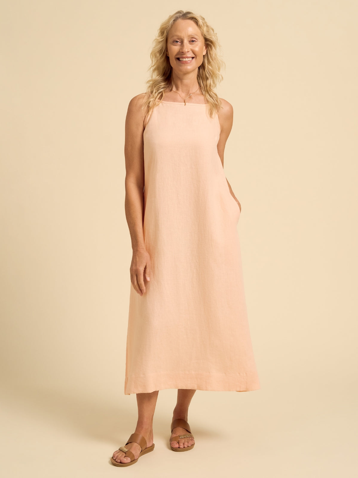Model wears Peony Linen Dress in Coral