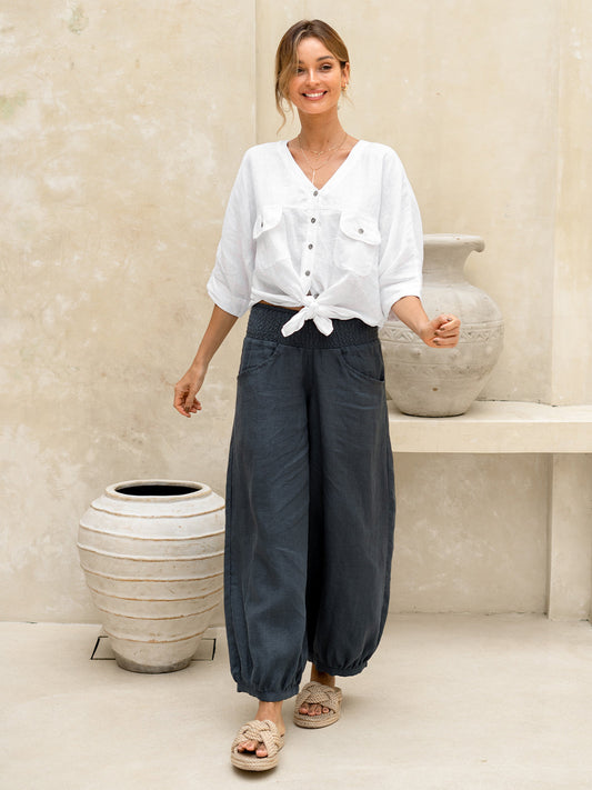 Model wears Sadhu French Linen Pants Regular in Charcoal.