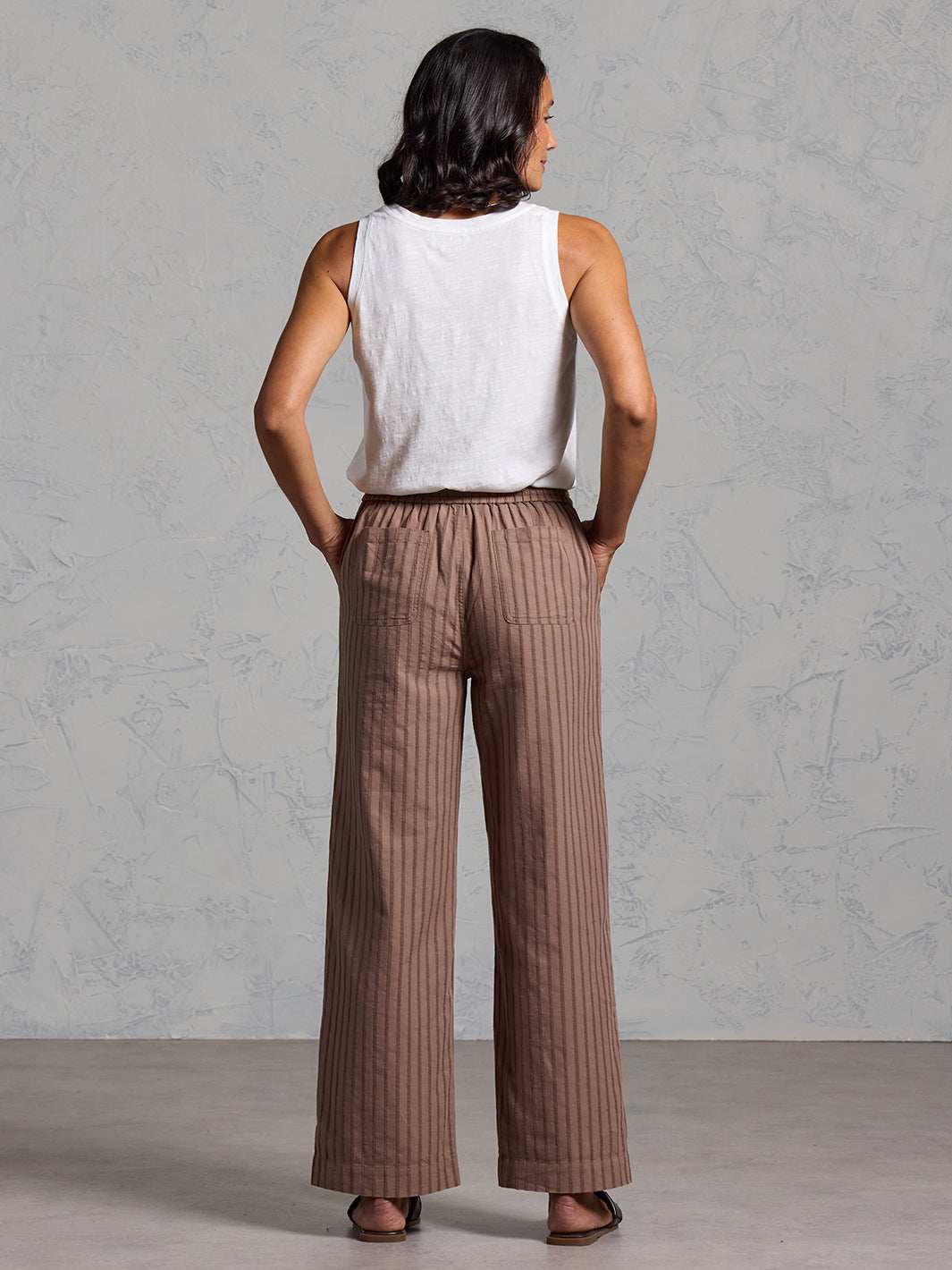 Woman wearing Sidari Organic Cotton Trousers Cinnamon from Nomad the Label