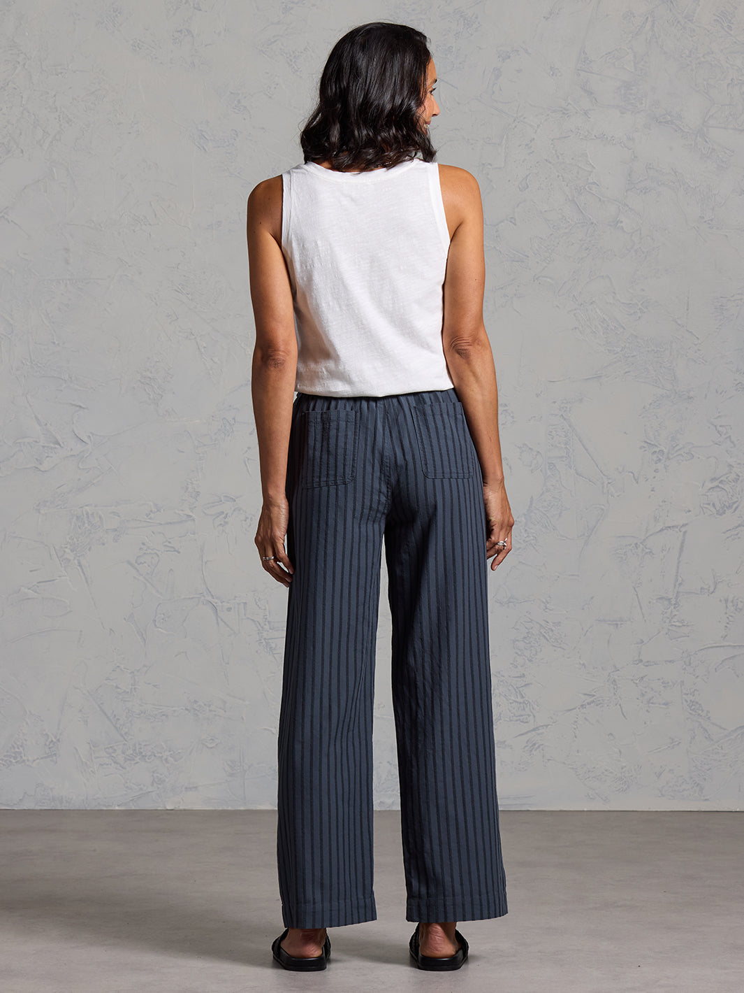 Woman wearing Sidari Organic Cotton Trousers Charcoal from Nomad the Label