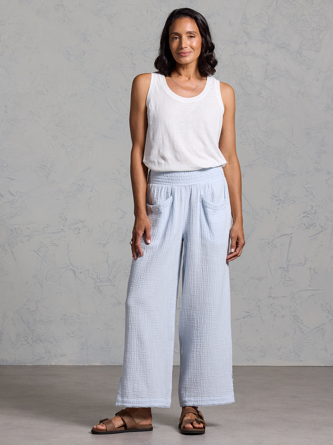 A woman wearing Sur Mer Organic Cotton Trousers Serene Blue and Yarra Cotton Top Coconut from Nomad the Label