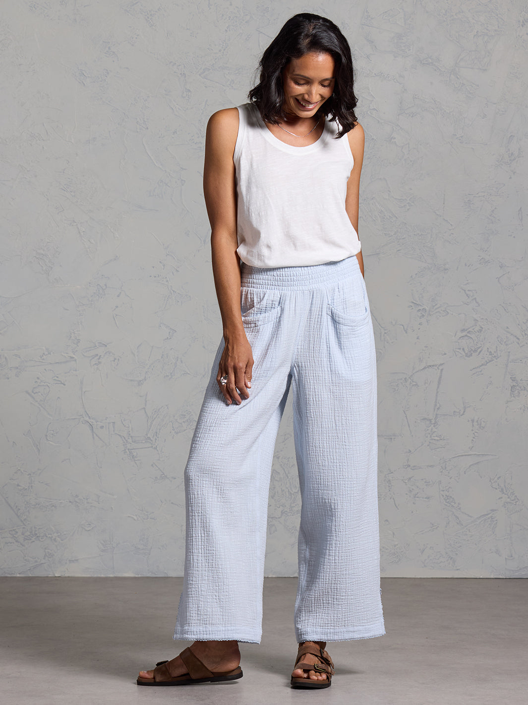 A woman wearing Sur Mer Organic Cotton Trousers Serene Blue and Yarra Cotton Top Coconut from Nomad the Label