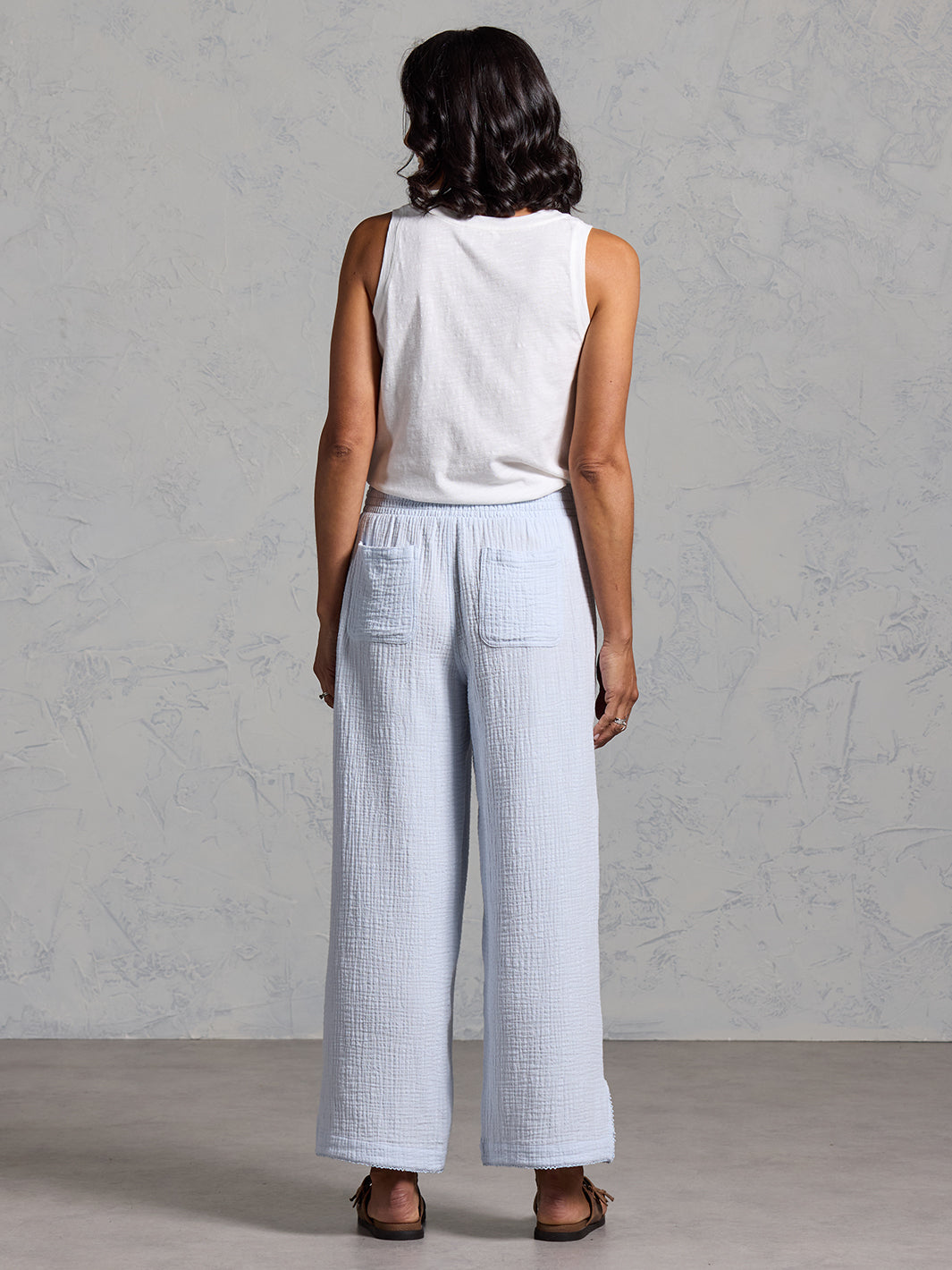 A woman wearing Sur Mer Organic Cotton Trousers Serene Blue and Yarra Cotton Top Coconut from Nomad the Label