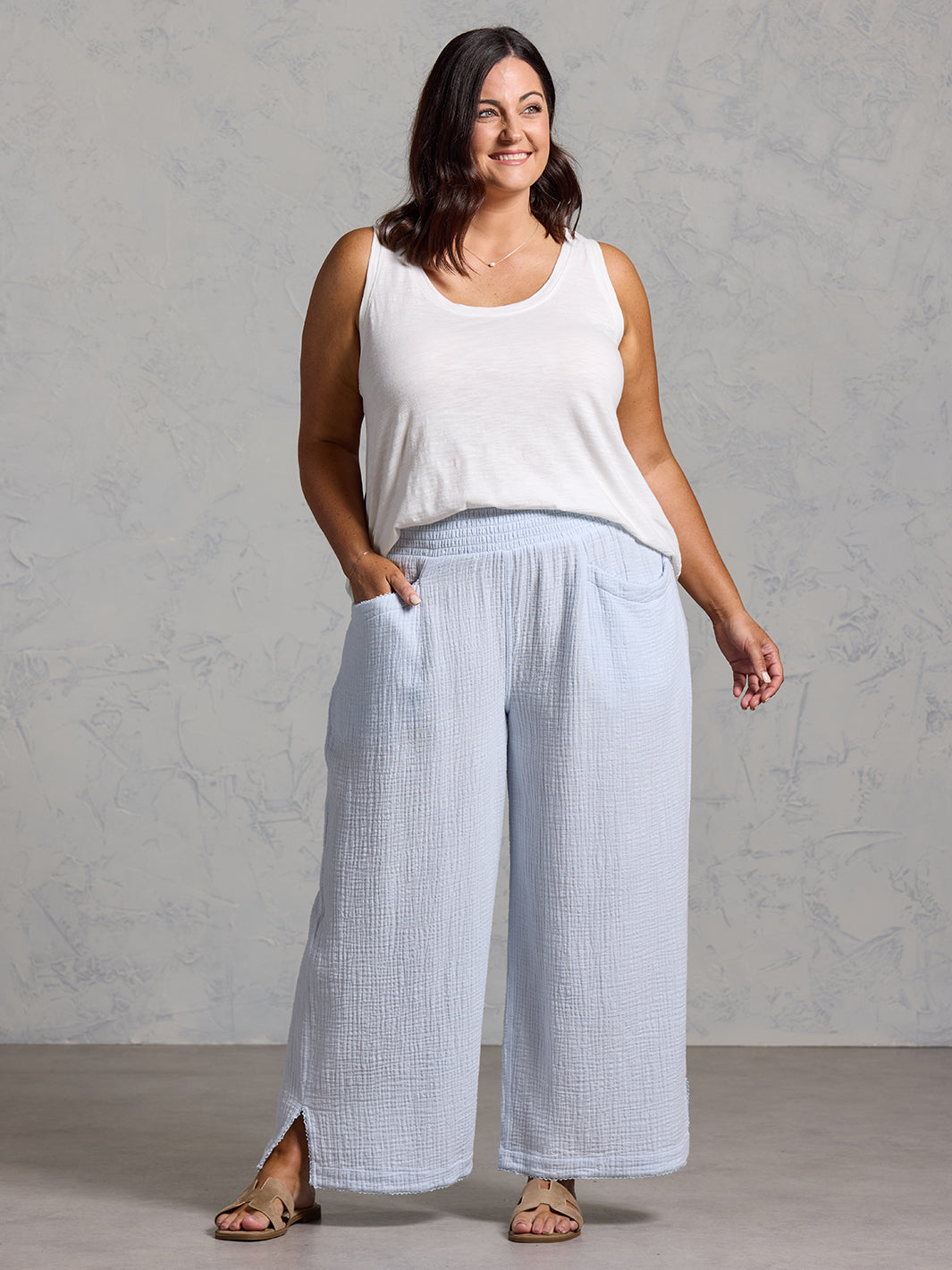 A woman wearing Sur Mer Organic Cotton Trousers Serene Blue and Yarra Cotton Top Coconut from Nomad the Label