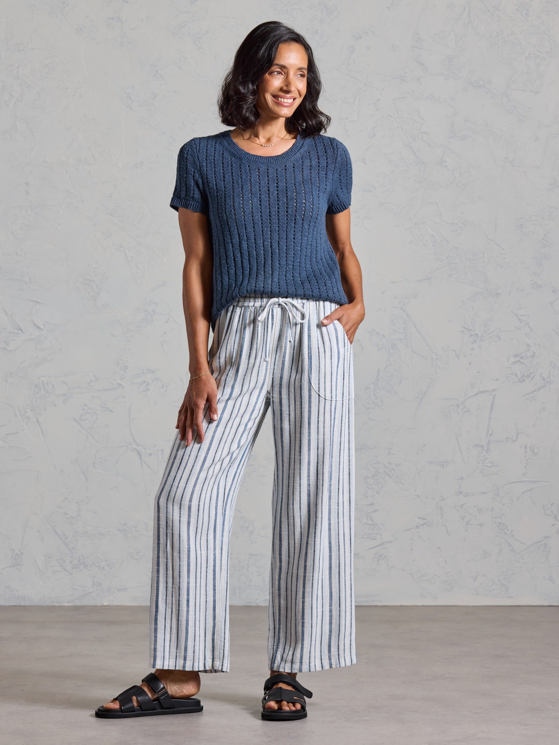 Full length view of the Jolie Linen Blend Trousers in coastal blue, paired with a navy knit top.