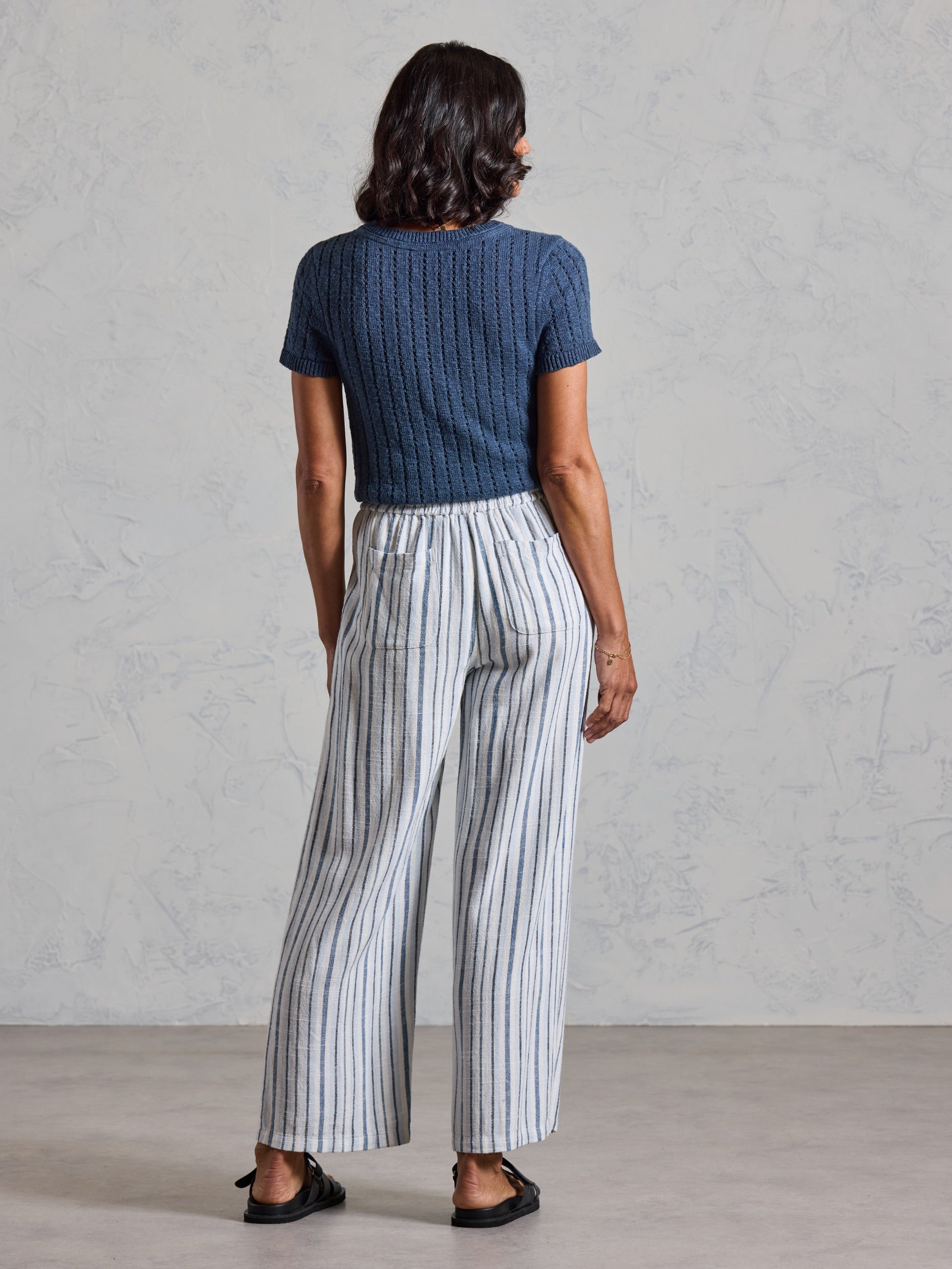 Back view of the Jolie Linen Blend Trousers in coastal blue, showing back patch pockets and wide leg drape.