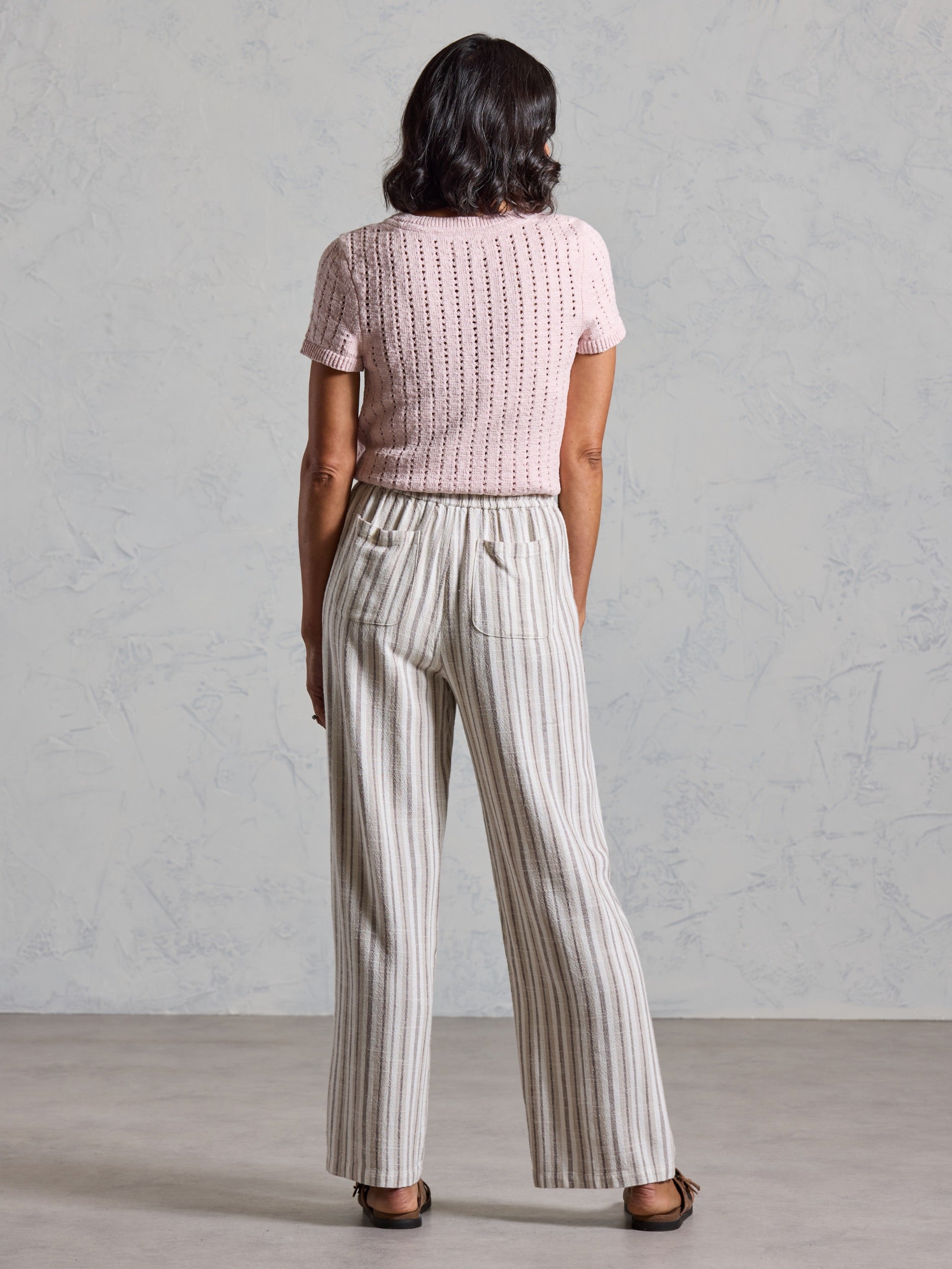 Back view of the Jolie Linen Blend Trousers in driftwood, showing back patch pockets and wide leg drape.