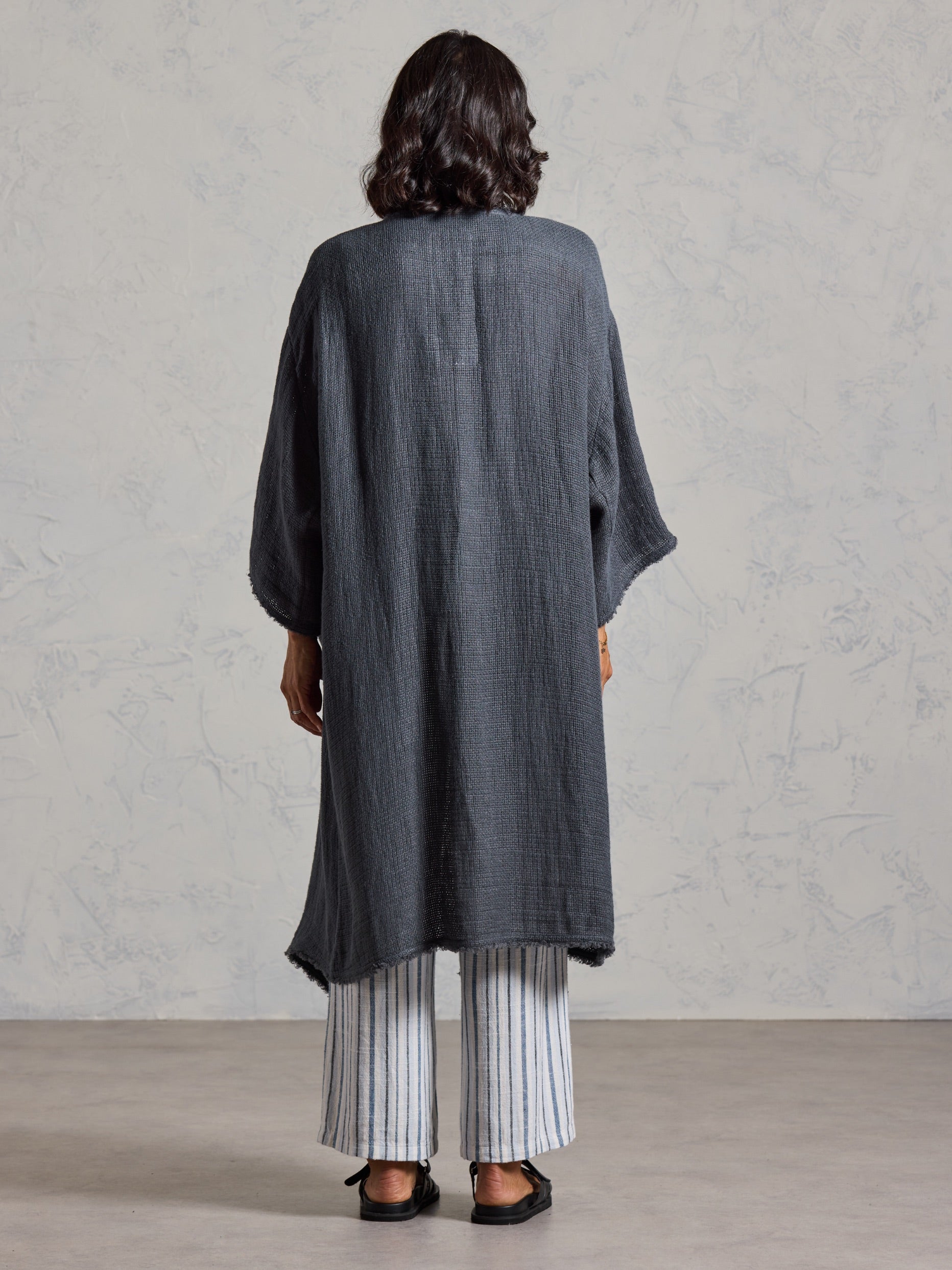 Back view of the Laguna French Linen Kimono in charcoal, showing the textured linen weave and relaxed fit.